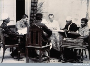 V0029678 A group of men taking notes at a table, during a plague epid